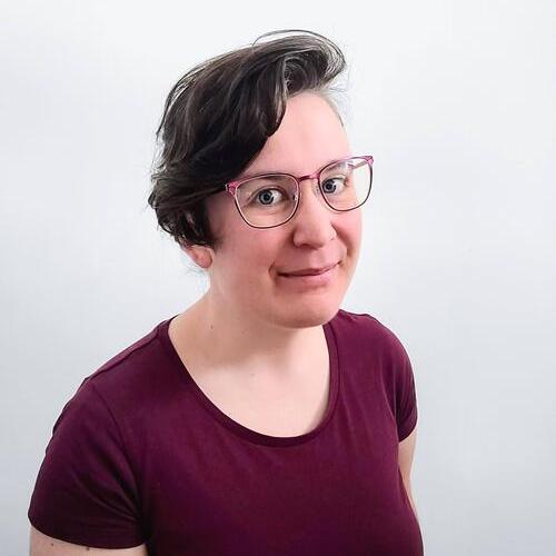 Profile photo of Rhian, smiling in a liminal space.