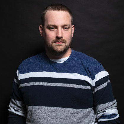 Profile photo of Tom with a natty jumper and an intense gaze.