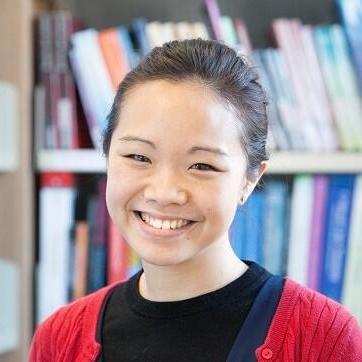 Profile photo of YiWen in a sea of books.